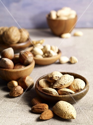 Different kinds of nuts in bowls