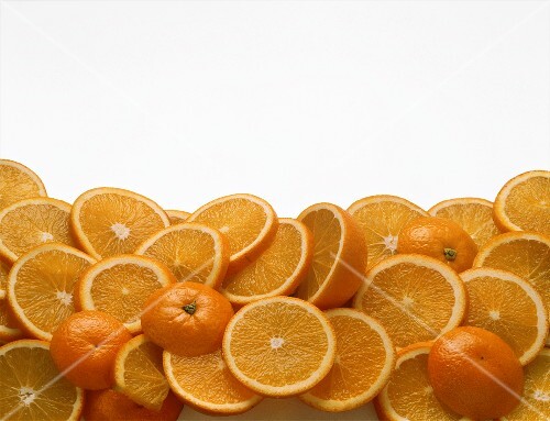 Slices of orange on sheet of glass