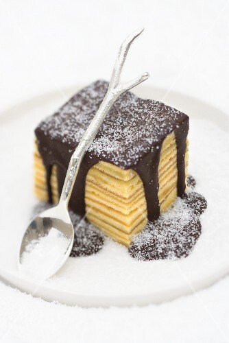 Baumkuchen (German layer cake) with chocolate sauce and sugar