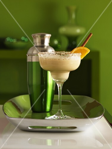 Frozen martini in a glass with sugar on the rim of the glassand a shaker