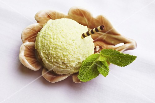 A scoop of peppermint ice cream with fresh mint