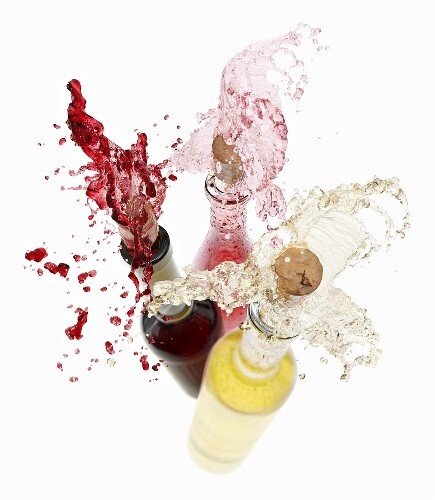 Wine spraying out of bottles (red wine, rose wine and white wine)
