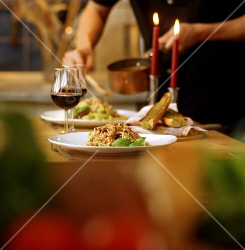 Man cooking pasta for a candlelit dinner