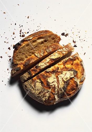 A crusty farmhouse loaf, slices cut