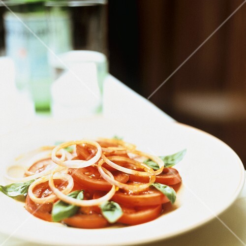 Tomato salad with onion rings and basil