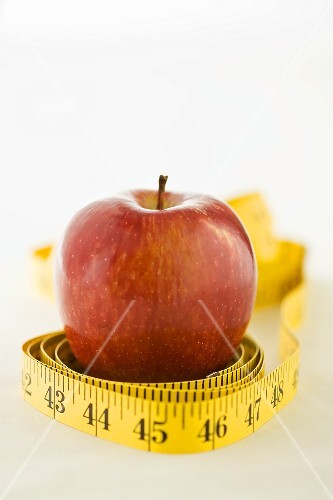 A tape measure around an apple