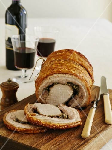 Rolled pork roast with crackling, partly carved