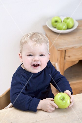 Small boy with a Granny Smith apple