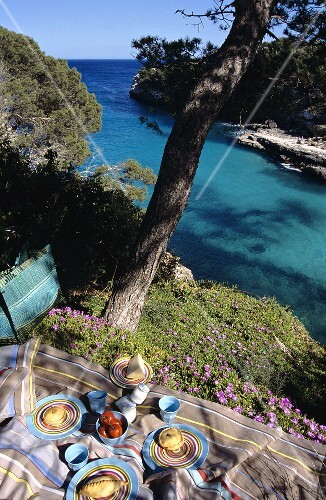 Picnic with pies, pasty and cheese at a coastal inlet
