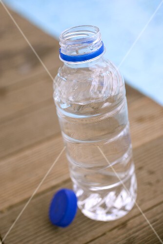 Bottle of water by swimming pool