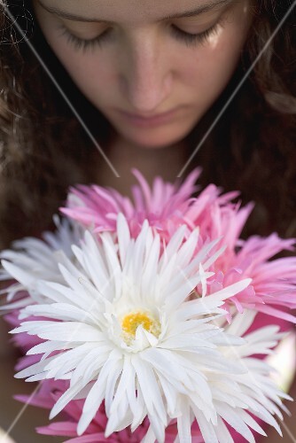 Young woman with bunch of summer flowers