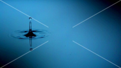 A drop falling into water (close-up)