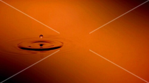 A drop falling into water (close-up)