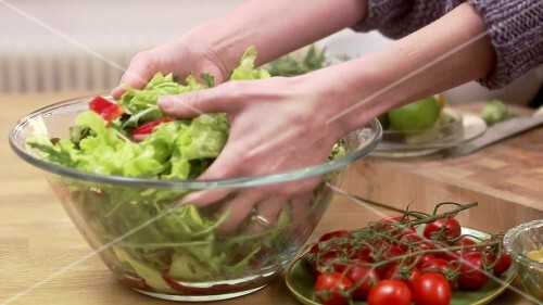 Dressing salad by hand