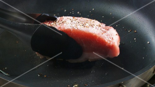 Frying loin of Iberian pork in a frying pan
