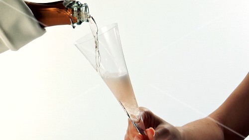 Pouring a glass of rosé sparkling wine
