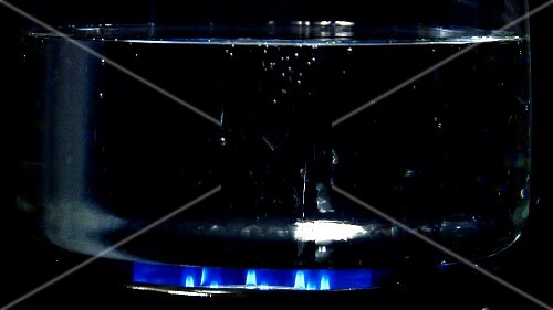 Boiling water in glass pan on gas flame