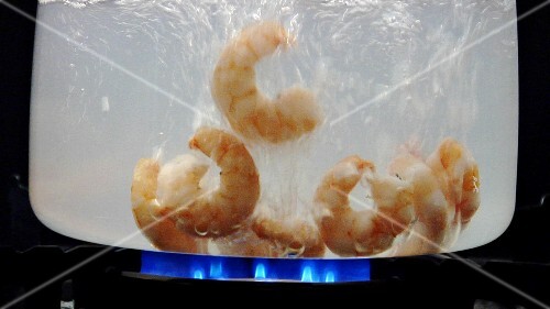 Peeled prawns in boiling water