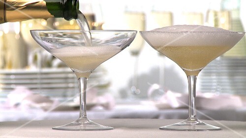 Champagne being poured into two glasses