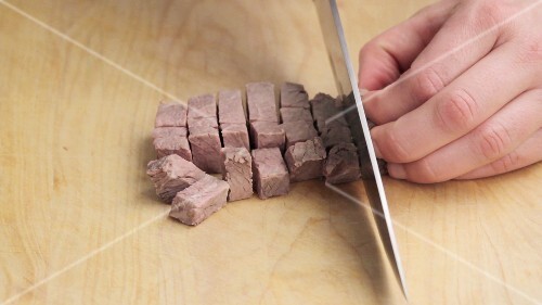 Cooked beef being diced
