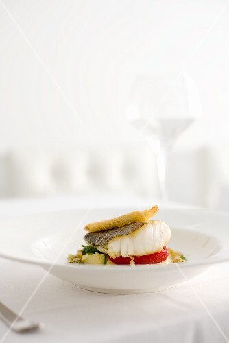 Fried cod fillet on vegetables