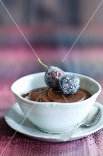 Chocolate Mousse in a Porcelain Bowl with Sugared Plum Garnish