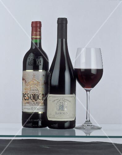 Bottle of Ribeira del Duero & of Barolo beside red wine glass
