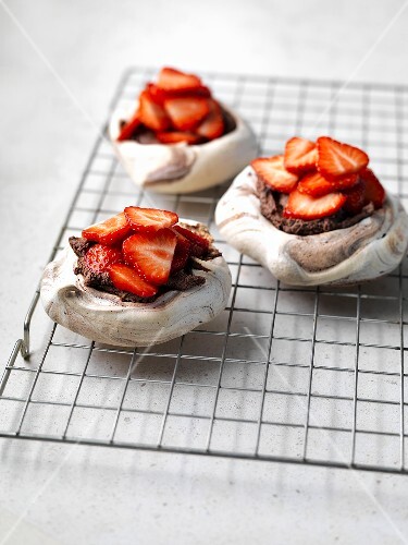 Three chocolate meringue tarts with strawberries