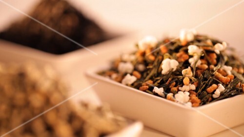 Dried tea leaves and a cup of tea