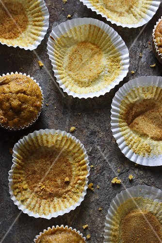 Empty paper cases and two remaining carrot muffins