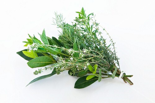 A bunch of herbs against a white background