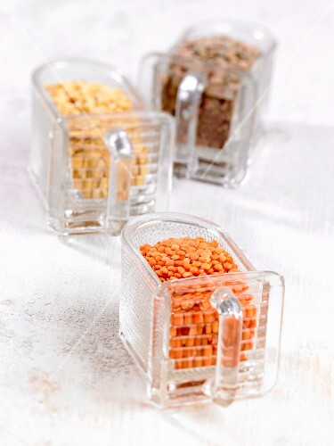 Red, yellow and brown laird lentils in boxes
