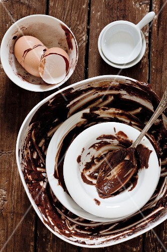 Bowls with the remains of a chocolate cake mixture and eggshells