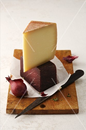 Gruyere, Grisons air-dried beef and onions on a chopping board
