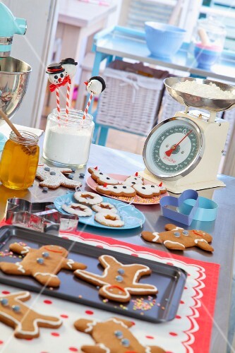 Various biscuits, cutter and ingredients on a kitchen table