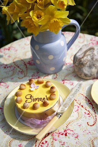 A simnel cake (English Easter cake) on a table in the garden