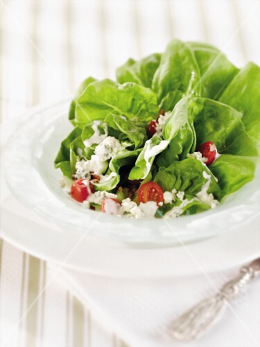 Bib Lettuce Salad with Blue Cheese and Grape Tomatoes in a White Salad Bowl