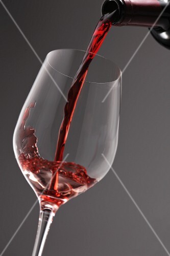 Red wine being poured into a wine glass