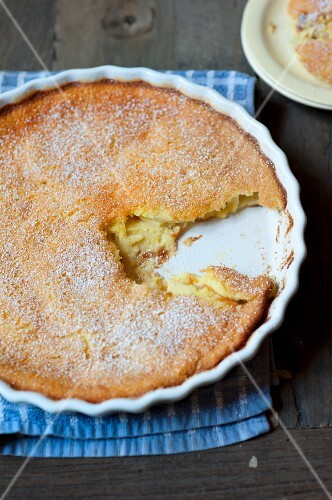 Pear Clafouti in a Baking Dish with a Slice Removed