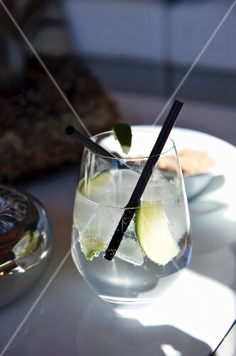 A refreshing drink with lemons and a straw