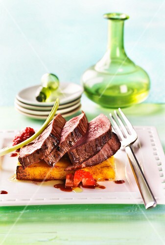 Roast beef on polenta with strawberry sauce