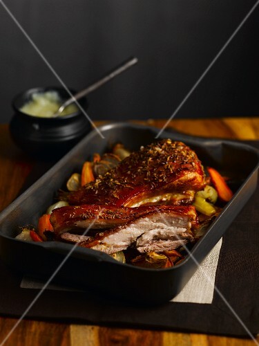 Crispy roasted pork belly in a roasting tin
