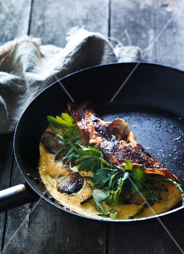 Omelette with potatoes and parsley in a pan