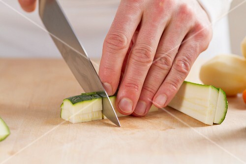 A courgette being chopped