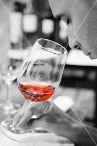 A man sampling rose wine