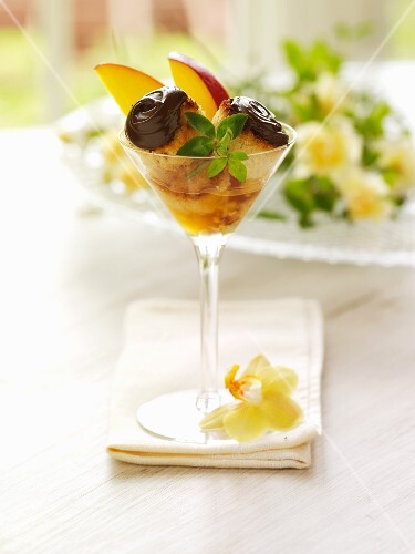 Chocolate Macaroons with Sliced Mango and Liqueur in a Martini Glass