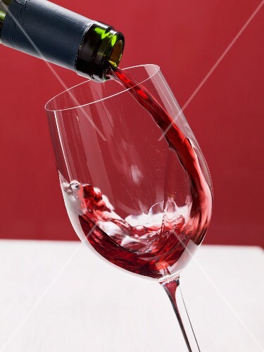 Red wine being poured into a wine glass