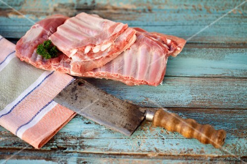 Raw pork ribs and a meat cleaver
