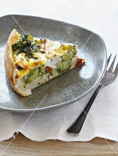 A slice of broccoli quiche with dried tomatoes