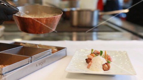 A chef arranging food on a plate in Steinheuers Restaurant in Heppingen